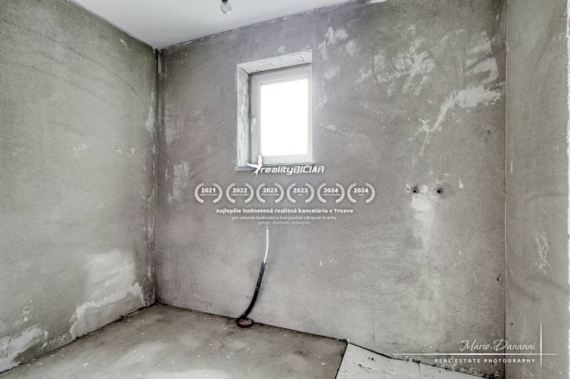 Concrete wall and small window in the interior of a family house.