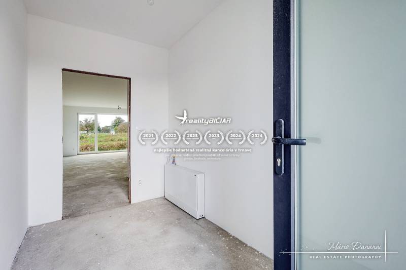 Interior of a family house with a bright room and a view of the garden.