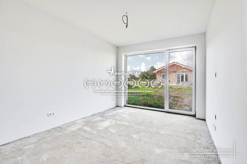 Empty room with a concrete floor and a large window in a family house.