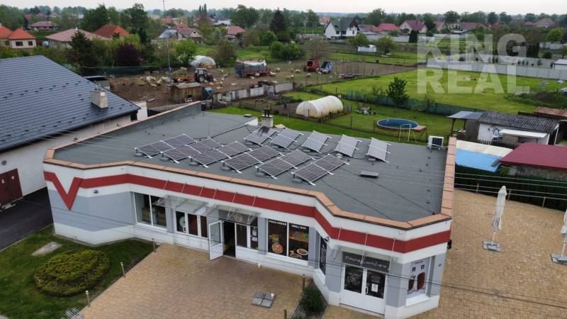 Commercial premises at Štefánikova 267 in Palárikovo with solar panels and a garden.