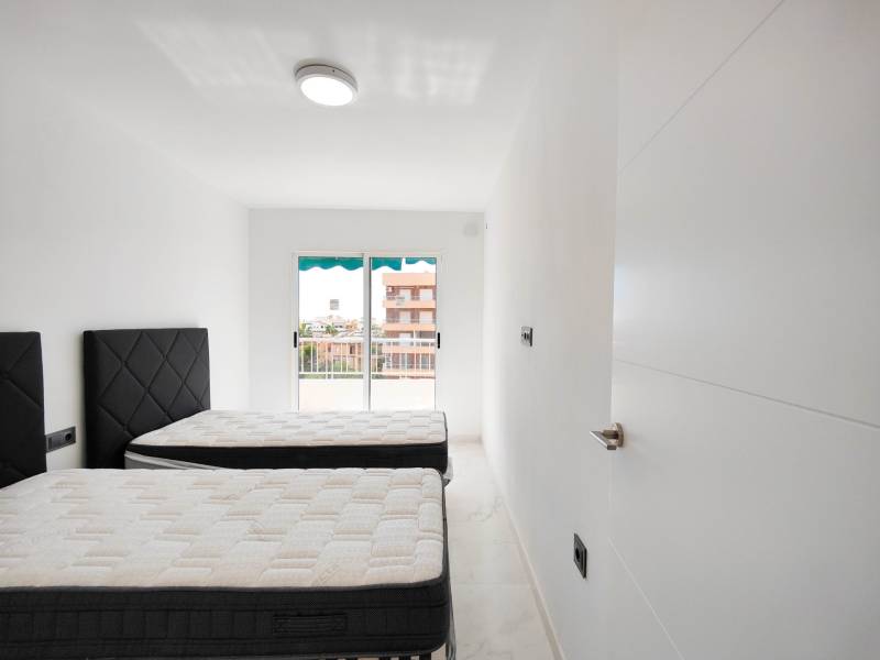 A bright bedroom with two beds in a 3-room apartment.