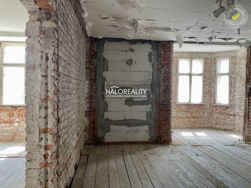 Interior of a family house with exposed brick walls and a wooden decor floor.