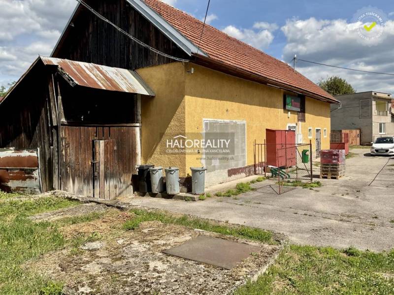 A family house in Jasenie with a wooden shed and an asphalt yard.