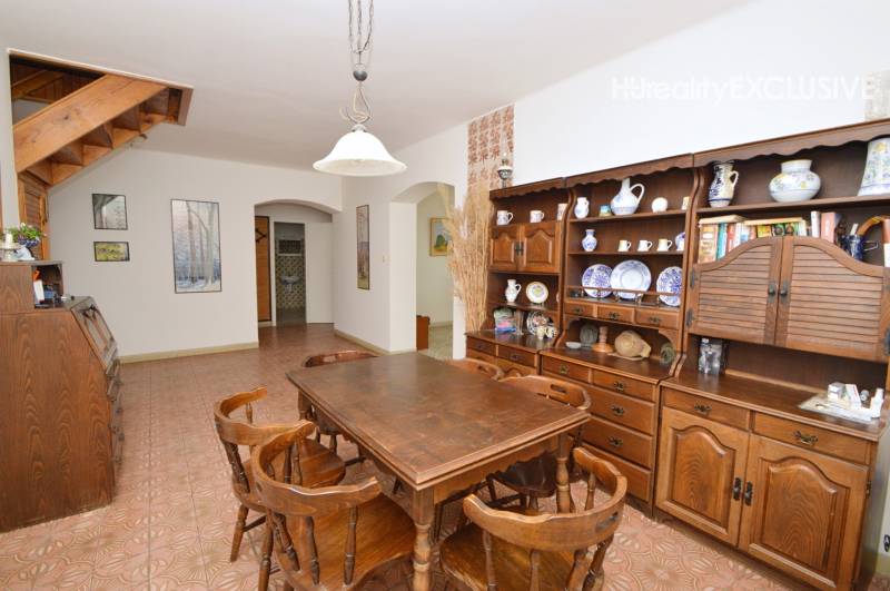 A dining room in a family house with wooden furniture and decorative ceramic accessories.