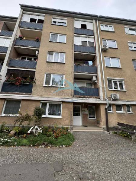 Apartment building on SNP Street in Šahy with balconies and a flower front garden.