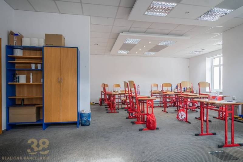 Office spaces with computers in the building, decorated with wooden doors and shelves.