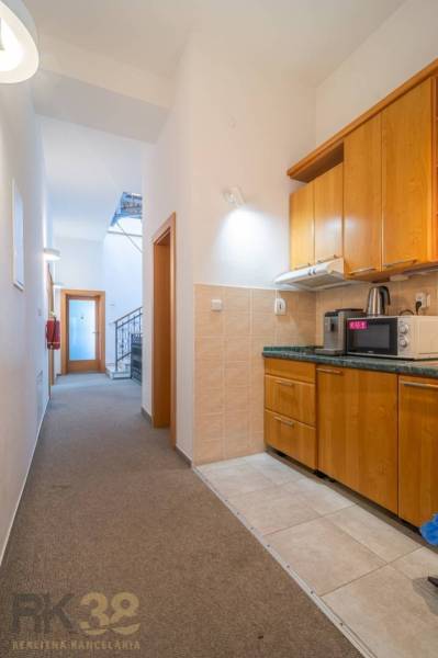 Interior in a building with wood-patterned flooring and a table.