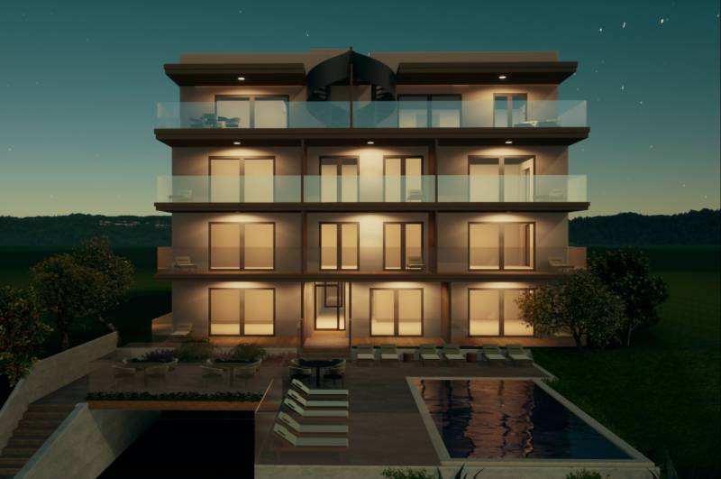 Evening view of an illuminated building with a pool in the city of Primošten.