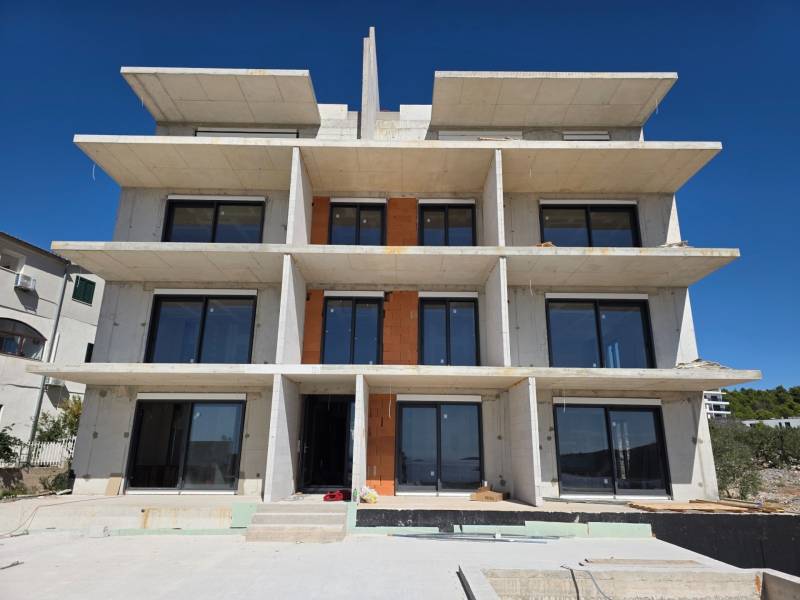 A multi-story building with large windows in Primošten, suitable for a 3-bedroom apartment.