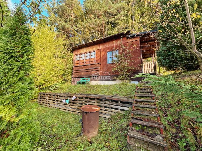 A wooden cabin surrounded by nature in the gardens of Budatín, Žilina.