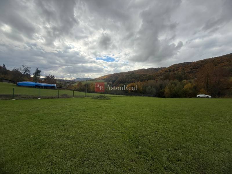 Spacious residential plots with greenery on Zbora Street, Púchov, surrounded by hills.