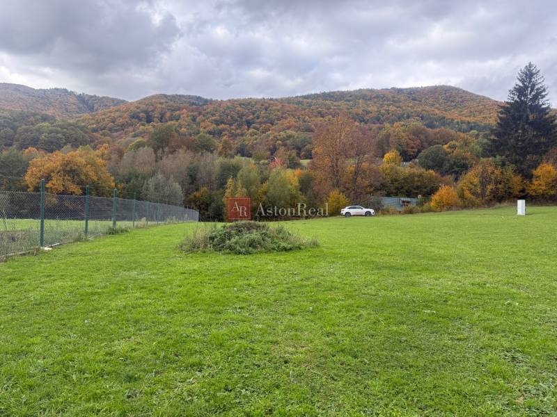 Green landscape on residential land in Zbor near Púchov with a mountain view.