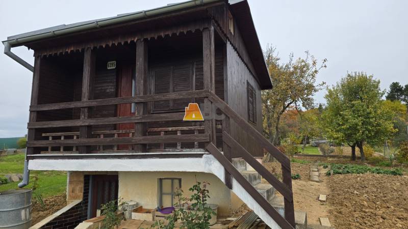 Wooden cottage with a garden and trees on A. Hlinka Street in Zvolen.