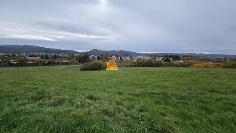 A view of the meadow and distant hills from the gardens in Zvolen on A. Hlinka Street.