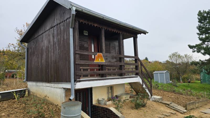 Wooden garden cottage in the Gardens on A. Hlinka in Zvolen, with a metal roof.