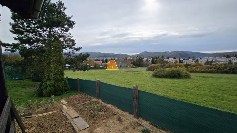 Gardens in Zvolen on A. Hlinka Street with a view of the hills and the housing estate in the background.
