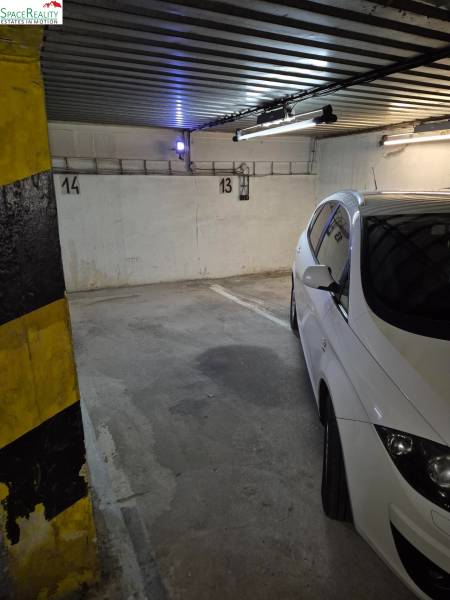 Parking spaces in garages with markings on the walls and yellow pillars.