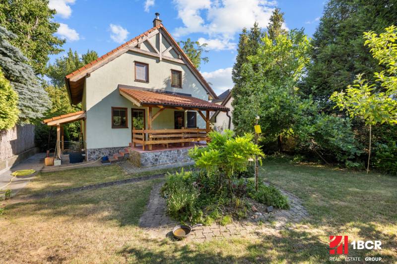 A family house on Senecká Street in Pezinok surrounded by a garden with trees.
