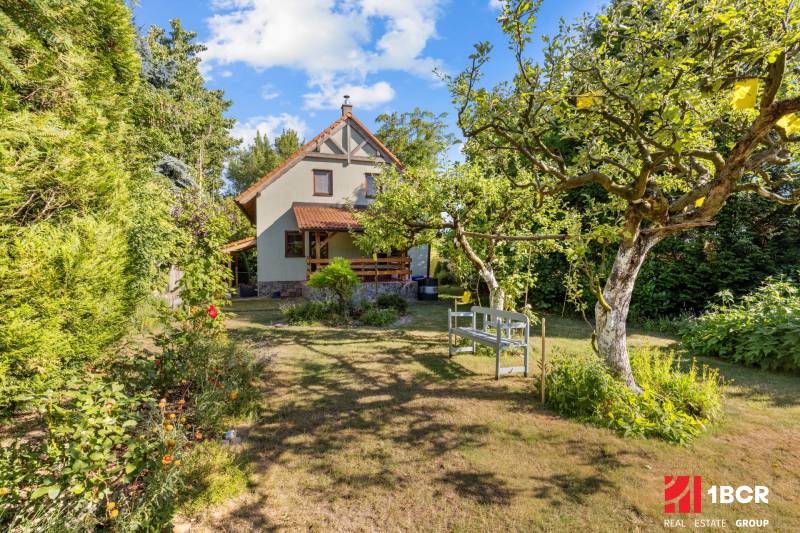 A family house on Senecká Street in Pezinok, surrounded by a garden with fruit trees.