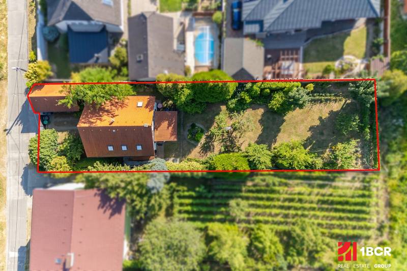 A family house on Senecká Street in Pezinok with a garden full of greenery.