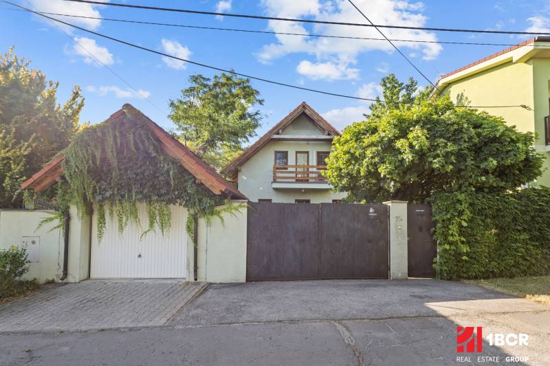A family house on Senecká Street in Pezinok, with a gate and greenery in the surroundings.