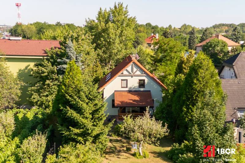 A family house in Pezinok on Senecká Street, surrounded by trees and a garden.