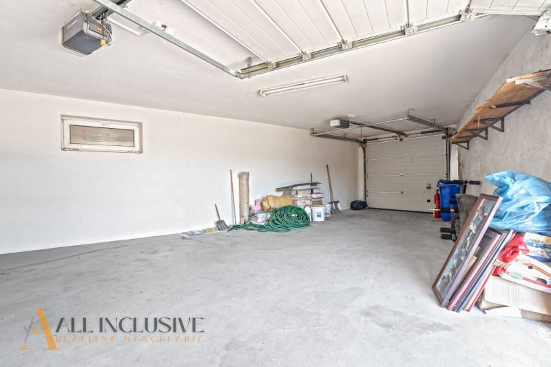 A garage with a concrete floor and various tools, commercial premises.