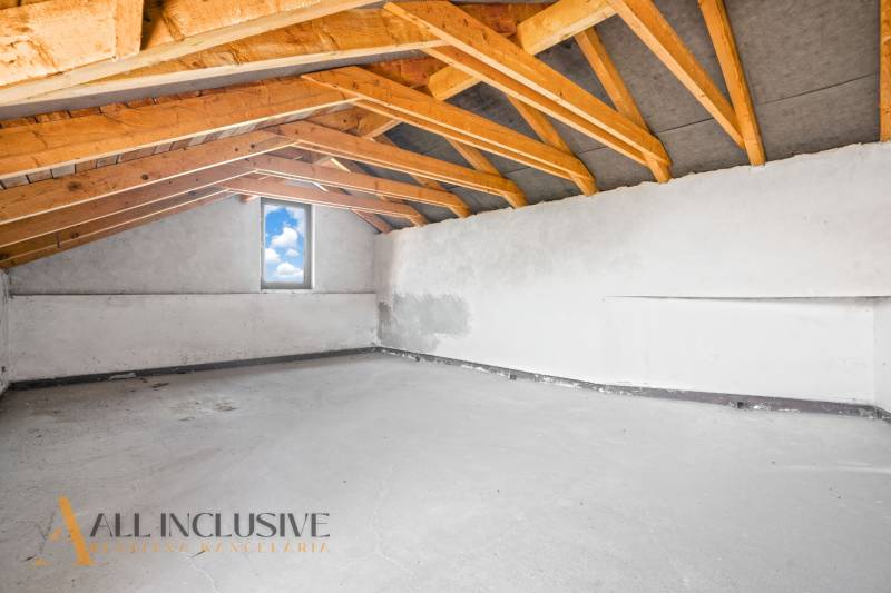 Ceiling with wooden beams and a window in commercial premises.