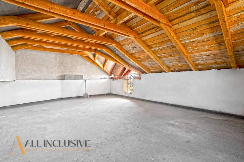 Attic commercial spaces with wooden beams and plenty of space for use.