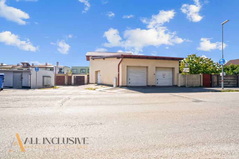 Parking lot with garages in commercial premises in Dunajská Streda under the blue sky.