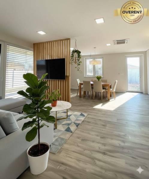 Living room in a family house with a wooden decor floor and stylish seating.