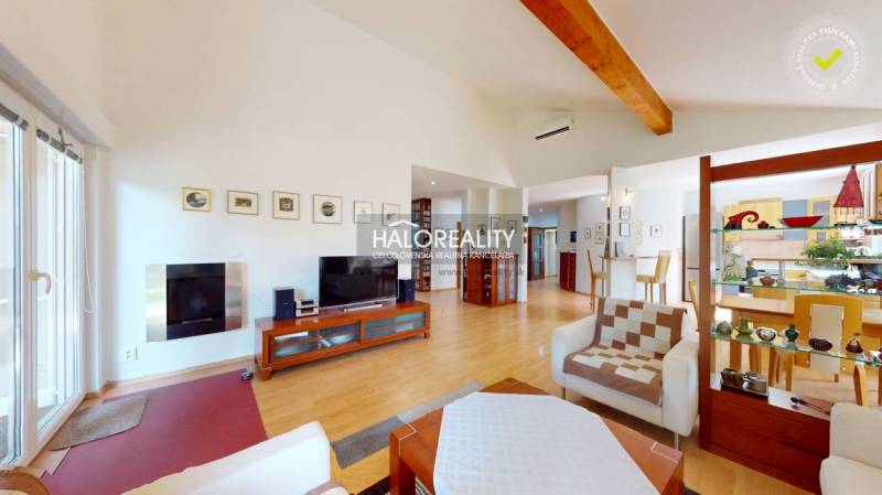 Living room of a family house with a wooden decor floor, television, and glass display cabinet.