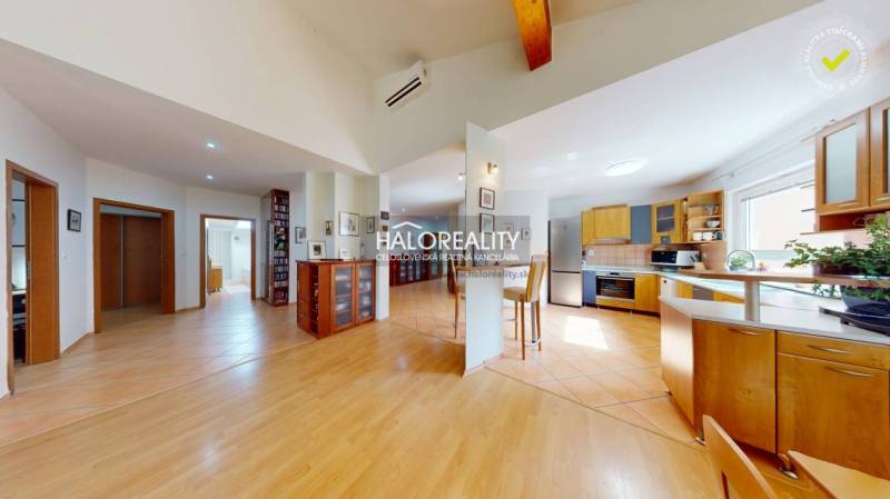 Interior of a family house with a wooden decor floor and a spacious kitchen.