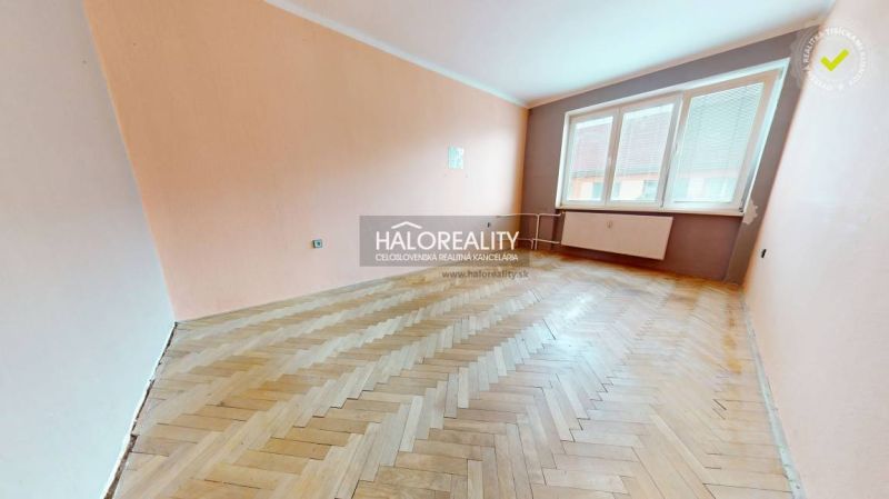 A spacious room in a 2-room apartment with a wooden decor floor.