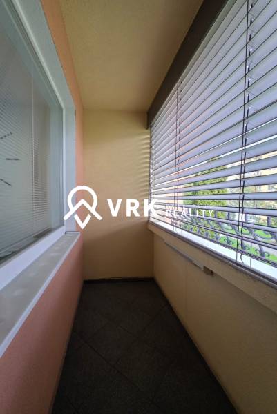 A balcony with tiles and blinds in a 1-bedroom apartment on Popradská Street, Košice - West district.
