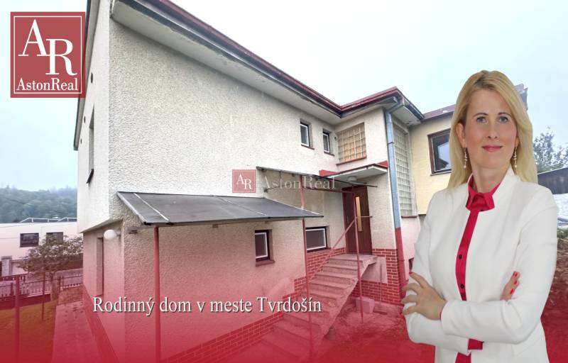 A family house in Tvrdošín with a floor and a staircase, greenery in front of the house.