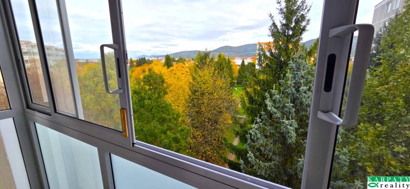 The view from the apartment on Trenčianska Street in Nová Dubnica with a park and hills.