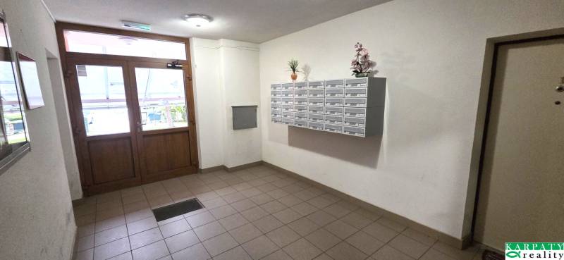 The entrance hall of an apartment building on Trenčianska Street in Nová Dubnica, with mailboxes.
