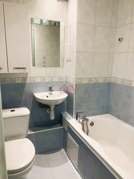 Bathroom in a 3-room apartment with a bathtub, sink, and toilet.