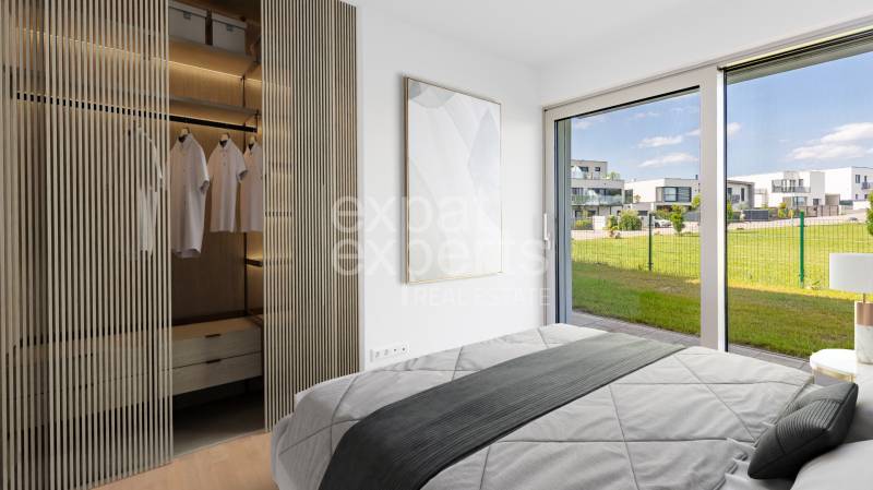 A bedroom with a view and a built-in wardrobe in a 4-room apartment.