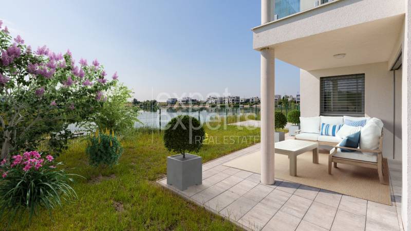 Terrace with a 4-room apartment in Kittsee, Am Seepark with a view of the lake and a garden.