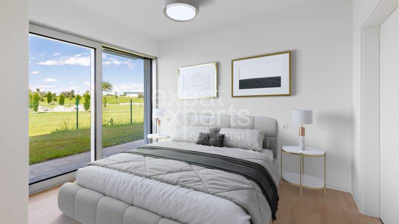 A bedroom with a large window and a wooden decor floor in a 4-room apartment.