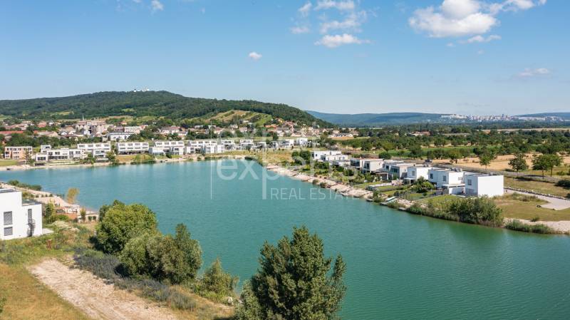 Lake surrounded by modern houses on Am Seepark street, Kittsee.