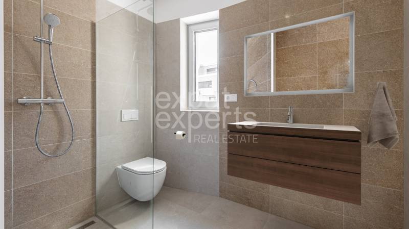 Bathroom with a shower in a 4-room apartment, tiles in natural tones, wall mirror.