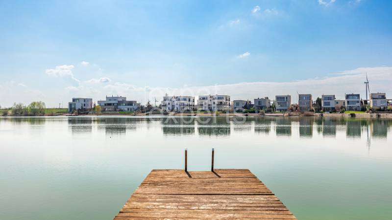 Wooden pier by the lake with a view of the properties in Kittsee, Am Strandbad.