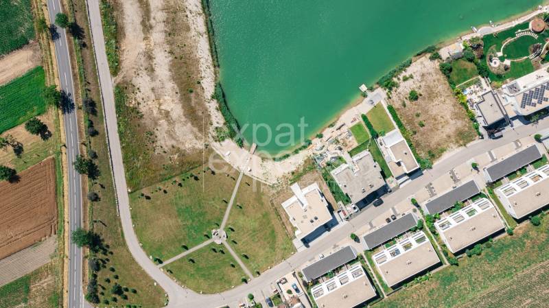 Aerial view of the streets Am Seepark in Kittsee near the lake and buildings.