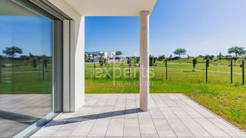 Terrace of a 4-room apartment in Kittsee, Am Seepark with a view of the green park.