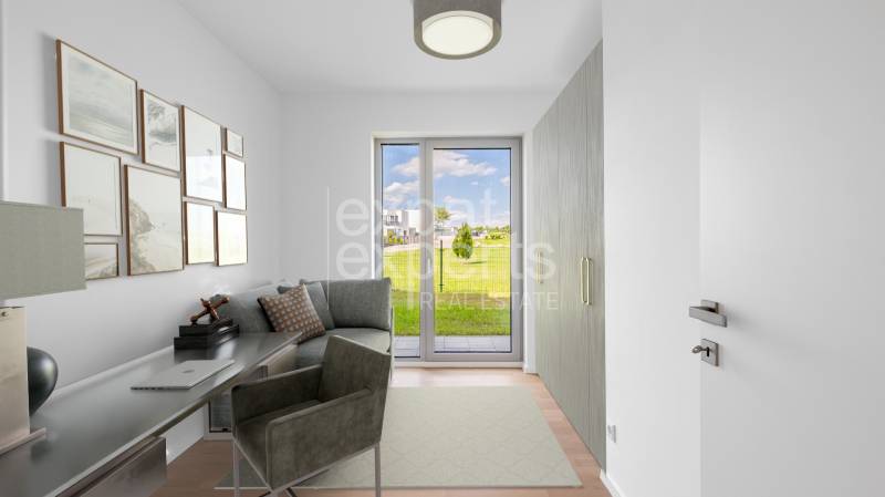 A study in a 4-room apartment with a view of the garden and a floor with a wooden decor.