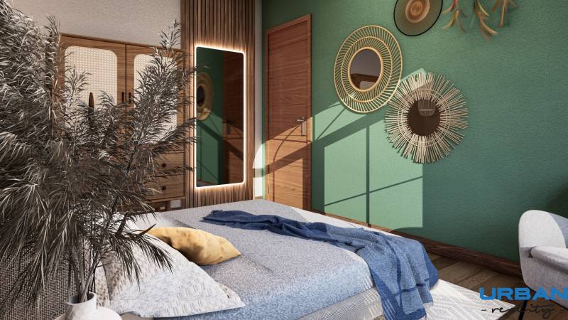 A bedroom in a one-room apartment with decorative mirrors, a green wall, and natural elements.