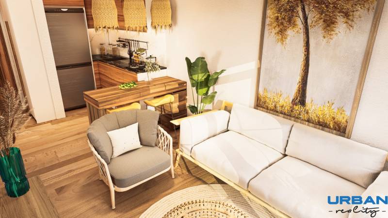 Living room in a one-bedroom apartment with a wooden decor floor and comfortable furniture.